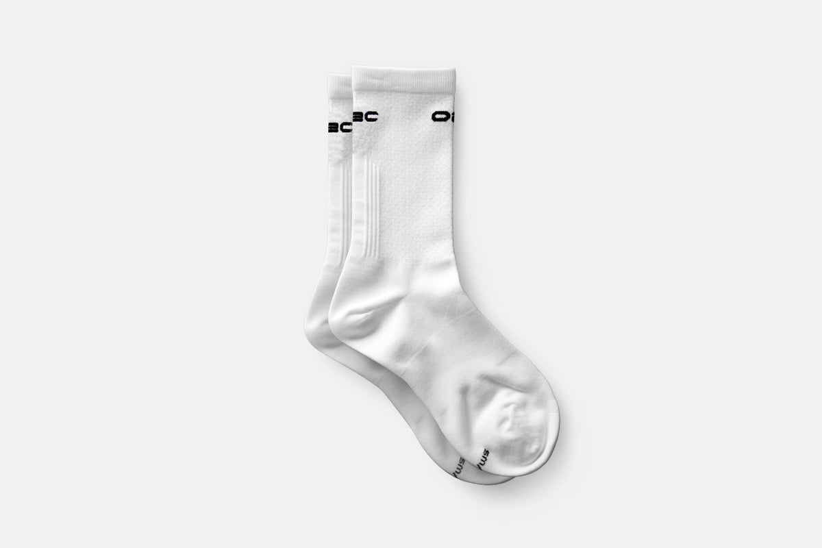 A pair of white cycling socks with O2C branding on white background